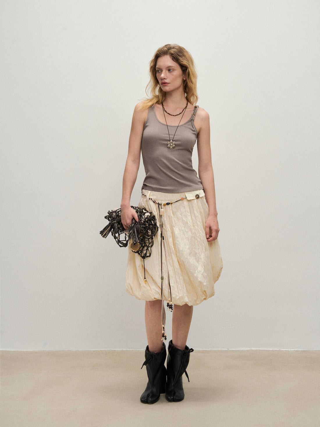 Dpercent 25SS A half-length skirt with slanted-cut and distorted texture structure