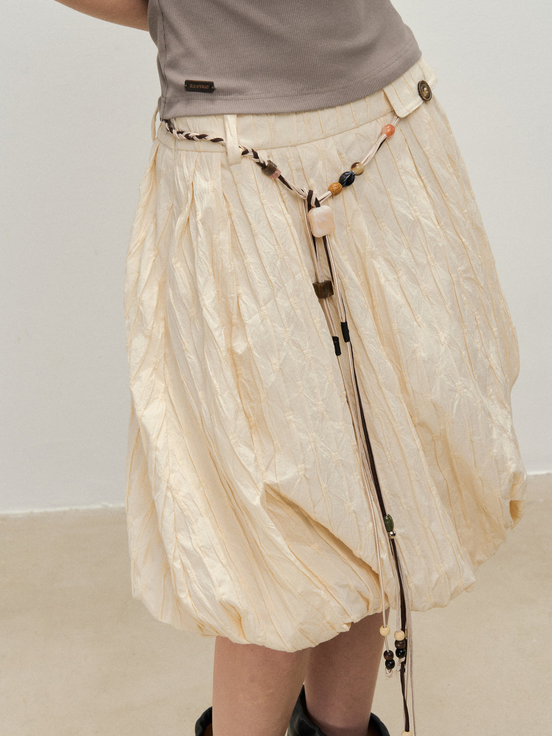 Dpercent 25SS A half-length skirt with slanted-cut and distorted texture structure