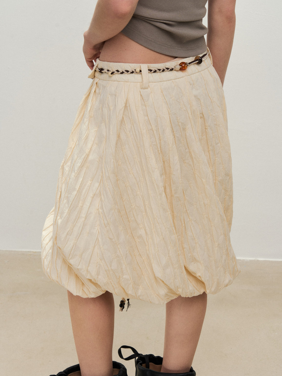 Dpercent 25SS A half-length skirt with slanted-cut and distorted texture structure
